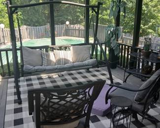 PATIO SWING, SWIVEL CAST ALUMINUM CHAIRS, BLACK AND WHITE RUG