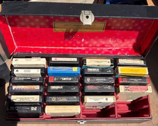 Vintage 8-track tape collection with multiple storage cases, featuring classic country, pop, rock, jazz, easy listening, soul, and soundtrack albums. Includes artists such as Frank Sinatra, Tony Bennett, John Denver, Sonny & Cher, Elton John, Funkadelic, Linda Ronstadt, Mel Tillis, Diana Ross, Tony Orlando & Dawn, and more. Also includes several 8-track carrying/storage cases filled with tapes