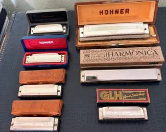 Vintage Harmonica Collection featuring several German-made Hohner harmonicas including Special 20 Marine Band models, Echo Harp, Chromonica in original wood case, Hohner Great Little Harp with box, and a Suzuki SU-24 tremolo harmonica
