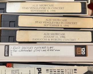 Large collection of VHS tapes and recorded media, including commercial movies, classical music, accordion concerts, instructional videos, Disney titles, home recordings, and numerous blank Maxell, TDK, and other premium VHS cassettes. Includes recordings of accordion performances, concerts, television broadcasts, and music programs, plus storage sleeves and cases