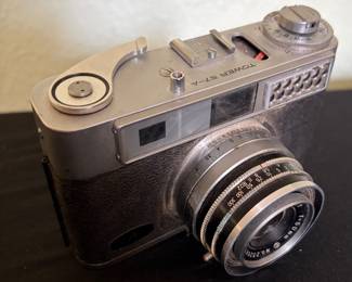 Tower 57-A 35mm rangefinder camera featuring a Tower 50mm f/2.8 lens with manual focus and exposure controls. Classic mid-century camera with a metal body