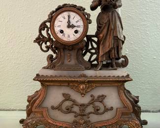 Antique French Figural Mantel Clock featuring a young woman reading atop a white marble base with ornate bronze-finished spelter mounts. Houses an 8-day French time and strike movement by Grivolat Frères Aînés. Circa 1880–1900