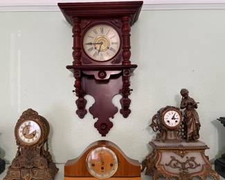 A beautiful selection of antique and vintage mantel and wall clocks, featuring ornate French-style cases, a Victorian wall clock, Art Deco styling, and classic mechanical wind-up movements