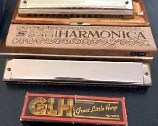 Vintage Harmonica Collection featuring several German-made Hohner harmonicas including Special 20 Marine Band models, Echo Harp, Chromonica in original wood case, Hohner Great Little Harp with box, and a Suzuki SU-24 tremolo harmonica