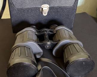 Binolux 7x50 fully coated binoculars with neck strap and protective lens caps. Full-size binoculars ideal for birdwatching, boating, sporting events, and outdoor use. Includes original carrying case.
