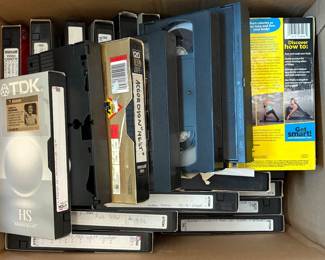 Large collection of VHS tapes and recorded media, including commercial movies, classical music, accordion concerts, instructional videos, Disney titles, home recordings, and numerous blank Maxell, TDK, and other premium VHS cassettes. Includes recordings of accordion performances, concerts, television broadcasts, and music programs, plus storage sleeves and cases