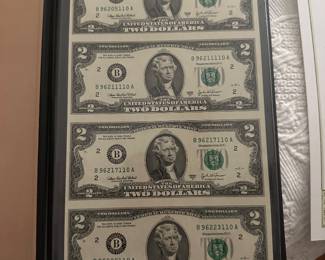 Uncut 2003 2 dollars bills in protective casing, 10x