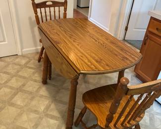 Kitchen table with 2 leaves, 41”L x 30”h, expands to 61” wide with leaves and wings, and 2 chairs