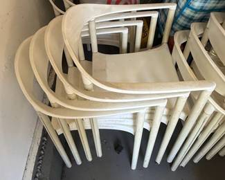 White Molded Plastic Stackable Armchairs each