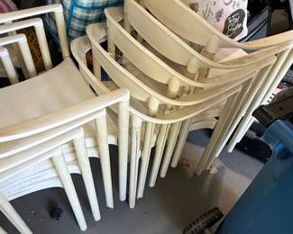 White Molded Plastic Stackable Armchairs each second image