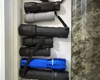 Assorted LED Flashlights and Red Multitool