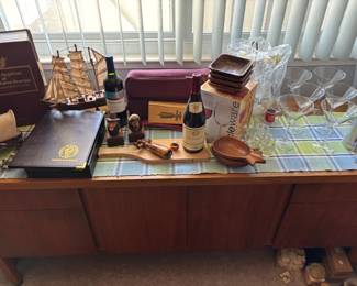 Assorted Collectibles Decorative Ship Model, Wines, Barware, USF Folder, and Stamp Replica Book