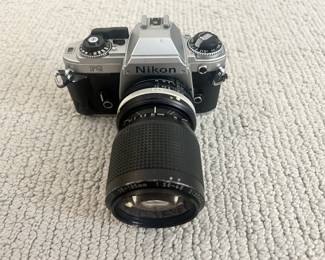 Lot 18 A Nikon FG 35MM SLR Camera with Nikkor 35-105MM Lens. Starting BID $100.00