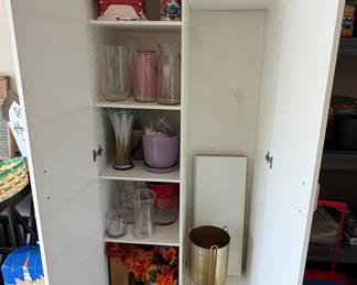 White Storage Cabinet with Assorted Decorative Items