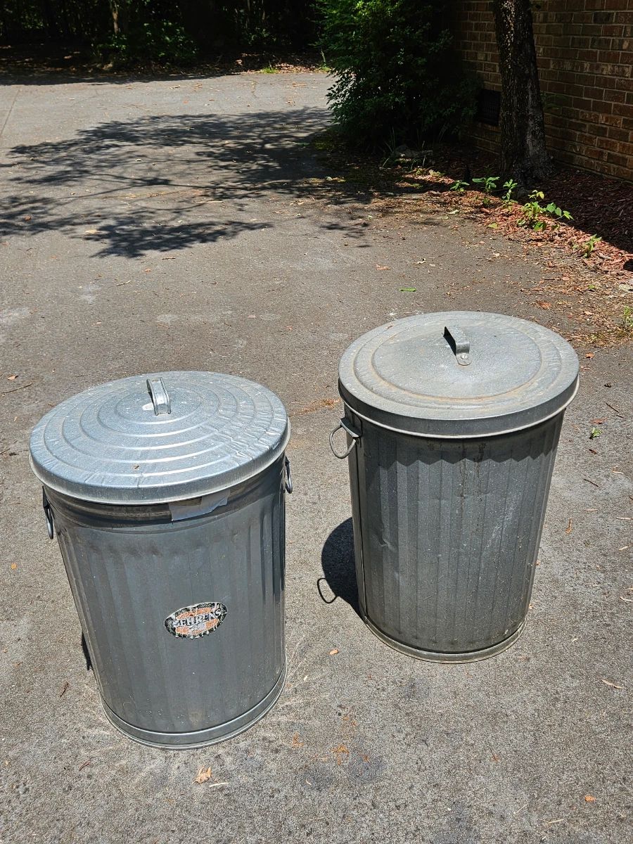 Metal trash cans all with lids