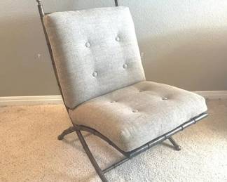 003 Hollywood Regency style lounge chair features a faux bamboo metal frame with a goldtone finish