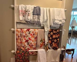 Tablecloths (more not pictured) Quilt rack not for sale