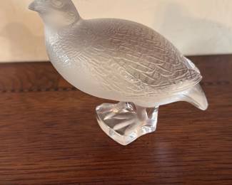 Frosted Glass Quail Figurine — Decorative frosted glass quail figurine with detailed feather etching and a clear glass base; great for a living room shelf or mantel. The piece is translucent with a matte frosted finish on the body and a polished clear base that shows light nicely. Measures approximately 4.5 inches tall, 6.5 inches long, and 2.5 inches wide, making it an easy tabletop accent. In good condition with no visible chips or cracks; base and feet intact and stable for display.