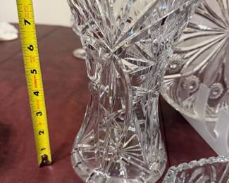 Pinwheel Starburst Pressed Crystal Bowl — Pinwheel and starburst vintage pressed crystal bowl featuring intricate cut-style pinwheel and starburst patterns throughout. Clear pressed glass with scalloped octagonal rim and heavy molded base; seller notes identify the decorative motif as pinwheel and starburst. Measures approximately 8 in diameter and 3 in tall, a medium-sized decorative serving or display bowl ideal for a dining room or buffet. Good condition with light surface wear and minor scuffs consistent with use; no visible chips or cracks in photos.