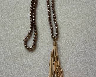 Faceted Metallic Bead and Suede Tassel Necklace