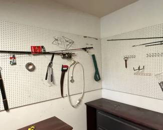 Assorted Garage Workshop Tools and Fishing Gear on Pegboard