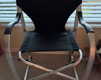Comfort meets convenience with this oversized folding director’s chair featuring a sturdy aluminum frame, durable black fabric seat and backrest, and comfortable molded armrests. Lightweight yet exceptionally sturdy, it’s perfect for extra seating on the lanai, patio, sporting events, camping, tailgating, or keeping on hand for guests. The wider seat and supportive design make it a comfortable choice for extended use, while the folding frame allows for easy storage when not in use.