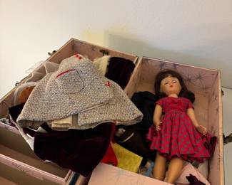 charming vintage doll collection featuring a classic hard vinyl doll accompanied by a beautifully organized wardrobe trunk filled with an assortment of clothing and accessories. This delightful collection offers nostalgic appeal and would make a wonderful addition to a doll collection, display cabinet, or gift for a collector. The decorative wardrobe trunk keeps outfits neatly organized and adds to the vintage presentation, making this a unique estate sale find.