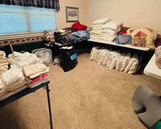 Lots of bedding and pillows 