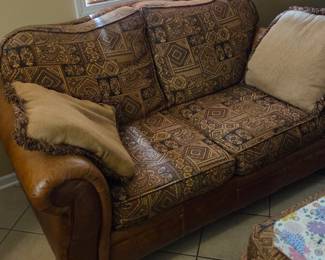 Fabric and leather love seat with matching ottoman