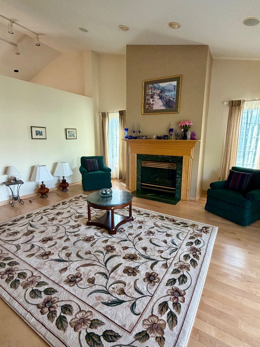 Antique lamps, large area rugs, emerald marble coffee table and end table, crystal vases and decor, living room chairs 