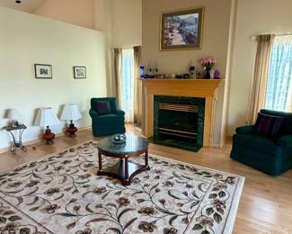 Antique lamps, large area rugs, emerald marble coffee table and end table, crystal vases and decor, living room chairs