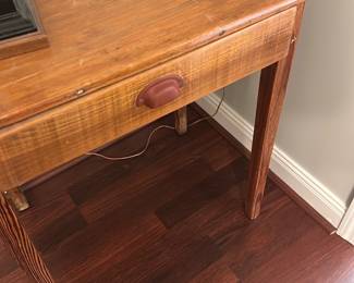 Pine One-Drawer Side Table — Simple pine side table with a single shallow drawer and cup-pull hardware, shown with surface wear, small dents and finish scuffs consistent with use. Straight square legs and a planked top give a rustic farmhouse look; useful as an entry, lamp, or bedside table. Construction appears solid though cosmetic blemishes are present on the top and edges. Compact footprint makes it easy to move and place in smaller rooms.