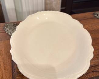 Thomas Langanier Ironstone Bowl — Thomas Langanier marked ironstone serving bowl with a scalloped rim and simple cream glaze. The backstamp reads "Thomas Langanier Best China" (as shown) and the bowl displays classic sturdy ironstone construction suitable for serving or display. Minor surface wear and small rim fritting visible at edges consistent with age and use; overall good, usable condition. Measures as listed below.