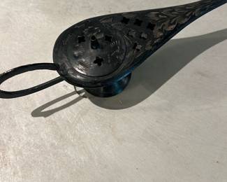 Brass Incense Burner Lamp — Small metal incense burner or oil-lamp style burner with an elongated spout and perforated round top for smoke/venting. Hand-etched floral/foliate decoration across the top and sides and a looped handle at the rear; dark patina present consistent with age. Functional decorative piece for use with charcoal or cone incense; shows surface wear and patina but no obvious dents or breaks visible in photos. Measures compactly and is easy to display on a shelf or mantel.