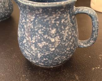 Blue Spongeware Creamer Pitcher — Blue spongeware ceramic creamer/pitcher with classic spattered white-on-blue glaze and a single loop handle. Sturdy wheel-thrown shape with a pour spout and glazed interior; base rim is unglazed with signs of normal use. Useful for table service or as a small decorative vase; no maker's marks visible in photos and overall condition is good with light surface wear inside and out.