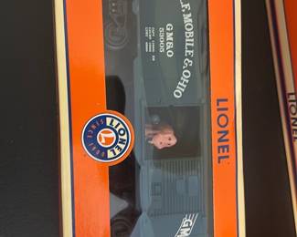 Lionel Gulf, Mobile & Ohio Boxcar — Lionel Gulf, Mobile & Ohio boxcar in original orange window box; box label reads "Gulf, Mobile, & Ohio Boxcar" and notes die-cast metal spinning trucks and sprung doors. The car appears unused in packaging with clear display window and bright box graphics showing Lionel branding. A solid collectible for model-train enthusiasts; box shows light shelf wear but overall condition is good.