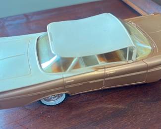 Chevrolet Brown Model Car — Diecast Chevrolet model car in brown with cream roof, detailed grille and interior steering wheel. Marked "Chevrolet" on the front hood and shows realistic chrome bumpers, whitewall tires and molded interior seats. Measures approximately 8.0 inches long, 3.0 inches wide and 2.5 inches tall — a compact display piece for an office shelf or automotive collection. Condition is good overall with surface scratches, minor paint wear and light dust consistent with age and display.