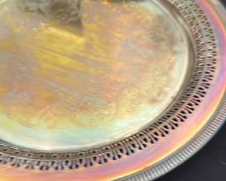 Silver plated server — Silver plated server with pierced gallery rim and engraved central decoration, described by the seller as a silver plated server. The piece shows iridescent toning and surface light wear consistent with age and use but no obvious dents or holes visible in photos. Good decorative serving piece for display or occasional use; measures roughly tabletop size as shown. Seller notes list it as silver plated.
