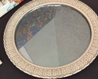 Pewter & Glass Pressed Frame or Server — Pewter and glass pressed glass frame with an ornate repeating border pattern and a round mirror insert. The pressed pewter-style rim shows decorative detailing; the glass has scratches and surface wear visible in close-ups and a small chip at the inner edge. Suitable as a decorative tabletop mirror or wall plate replacement; light tarnish and wear consistent with age.
