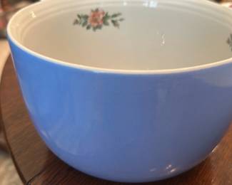 Hall's Rose Parade Mixing Bowl — Hall's Superware 'Rose Parade' mixing bowl in pale blue exterior with small rose decal clusters inside; made in U.S.A. and marked on the base. Sturdy, mid-century kitchenware made for everyday use, glazed ceramic with a simple ribbed rim detail. Estimated dimensions fit a medium mixing bowl useful for prep or serving; see measurements below. Good vintage condition with light surface wear and minor base scorch marks from use, no visible chips or cracks in photos.