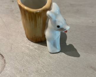 Occupied Japan Toothpick Holder — Small novelty porcelain toothpick holder marked "MADE IN OCCUPIED JAPAN" on the base. The piece resembles a standing tooth with glazed white enamel and a brownish glazed cavity/holder; it is a collectible souvenir produced during the Occupied Japan period (late 1940s–early 1950s). Condition shows age-related surface wear and light staining on the base as pictured but no obvious chips or large cracks. Compact and lightweight, suitable for display with other mid-century souvenir ceramics.