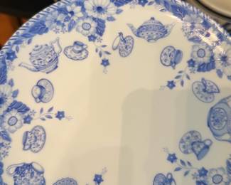 The English Tea Collection Plate — Decorative porcelain plate from "The English Tea Collection" featuring blue transferware teapots, cups and floral border motifs. The backstamp reads "The English Tea Collection" and includes an additional mark; plate shows glossy finish with no visible chips or cracks in the photos. A charming collector's or kitchen display piece that pairs well with other blue-and-white transferware; see photos for condition.