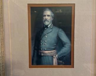 Framed Portrait with stamp — Framed portrait print of Robert E. Lee matted with a small matching stamp below the image. The piece is double-matted in a dusty rose/beige tone with a wood-grain frame; glazing is intact though there is surface reflection in photos. Good decorative condition with light signs of age to mat and frame; appears ready to hang as shown.