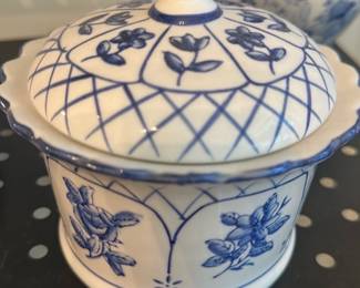 Blue Floral Covered Porcelain Jar — Small blue-and-white porcelain covered jar with hand-painted floral panels and lattice pattern on the lid. The piece has a scalloped rim and a round knob on the lid; decoration resembles traditional Delft or transferware styles. Good overall condition with only light surface wear visible in photos and no obvious chips or cracks. Compact size works well for table use, vanity storage, or display with other blue-and-white wares.