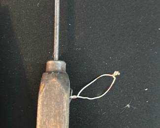 Ice pick — Solid hand tool with a turned wood handle and a long tapered steel awl point for scribing, punching or marking — typical of a craftsman's scratch awl. The wood handle shows surface wear, patina and small chips consistent with regular use; the steel shaft has age-related discoloration and light surface rust. Simple, sturdy construction and a comfortable grip make it useful for woodworking, leatherwork or hobby tasks. Measures as a compact hand tool and is sold as shown.