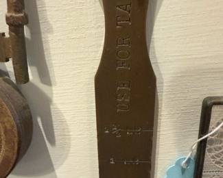Brass Tool — Stamped metal tool with raised lettering reading 'USE FOR TAPH' and calibrated marks along the blade. Heavy, flat forged steel construction with a dark patina consistent with age and use; appears to be a specialized hand tool or gauge with three stamped measurement lines. Solid condition with surface rust/patina and light wear around the edges but no breaks. Measures compactly and is suitable for display with other metal tools or for a collector of vintage hardware.