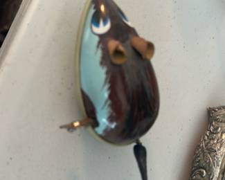 enameled mouse windup — Small enameled mouse trinket box with a hinged top and a painted fur motif in brown and pale blue. The piece has a metal rim and delicate painted eyes and ears; tail appears to be attached and slightly flexible. Good collectible condition with minor surface wear and tiny paint nicks consistent with age and light use. Compact decorative item ideal for jewelry or small keepsakes.