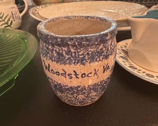 Woodstock, Va. Blue Speckled Pot — Handmade blue-and-white speckled pottery cup or small vase inscribed “Woodstock, Va.” on the side and signed on the base. Rustic, unglazed interior with a rolled rim and a salt-glaze or sponge-decor finish; maker's name on base appears to read "FRAN." Appears in good used condition with normal kiln/age surface wear but no visible cracks or chips in the photos. Compact decorative piece suitable for a shelf, desk, or as a small planter; dimensions below are estimated from photos.