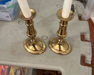 Pair Brass Candlesticks — Pair of brass candlesticks with octagonal bases and turned stems, good solid weight and classic simple profile. Both show surface patina and light verdigris inside the sockets consistent with age and prior use; no visible dents or breaks. Sturdy enough for tapered candles or as decorative bookends/accents. Each measures approximately 6.5 inches tall with a roughly 3.5-inch base diameter.