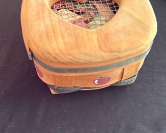 small wooden heart lid basket — Small woven wooden basket with a fitted wooden lid that has a heart-shaped cutout covered with mesh. Painted tiny apple motifs around the sides and filled with potpourri in the photos; rustic, country-style look. Lid and basket show light surface wear and patina consistent with age and use but no major damage; mesh over heart is intact. Handy for small trinkets, jewelry, or as a decorative potpourri holder.